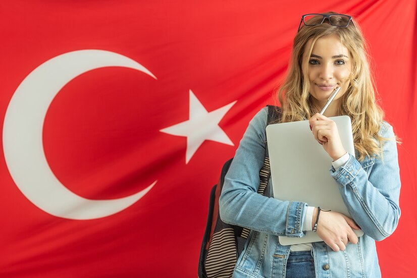 laptop pen holding blonde student smiles with turkish flag background 341862 706